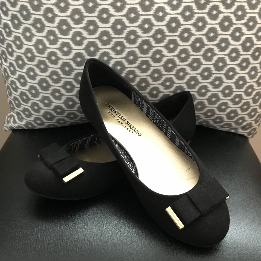 Black flats with gold accents on the bow and heel